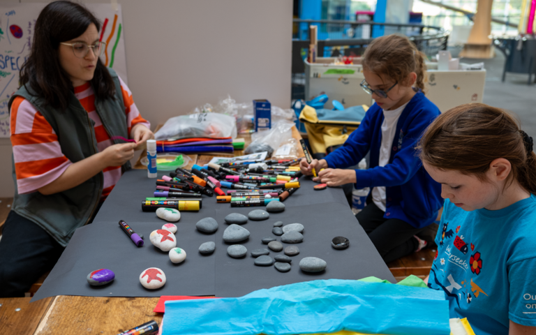 children decorating rocks with artist Milly Rolle.