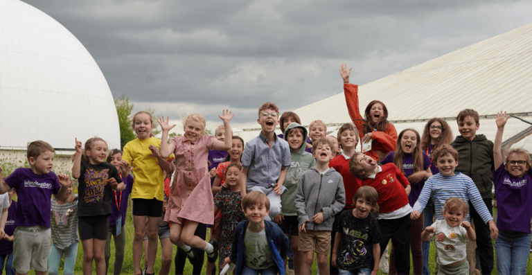 Children jumping in the air while smiling and laughing