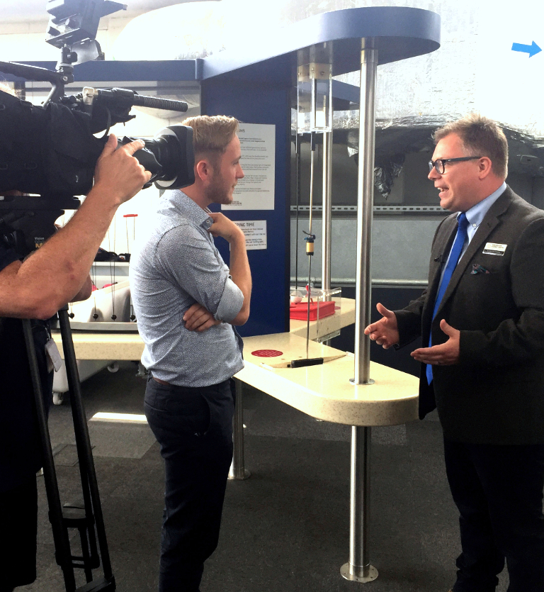 Winchester Science Centre's CEO talking with an interviewer with a camera man looking on